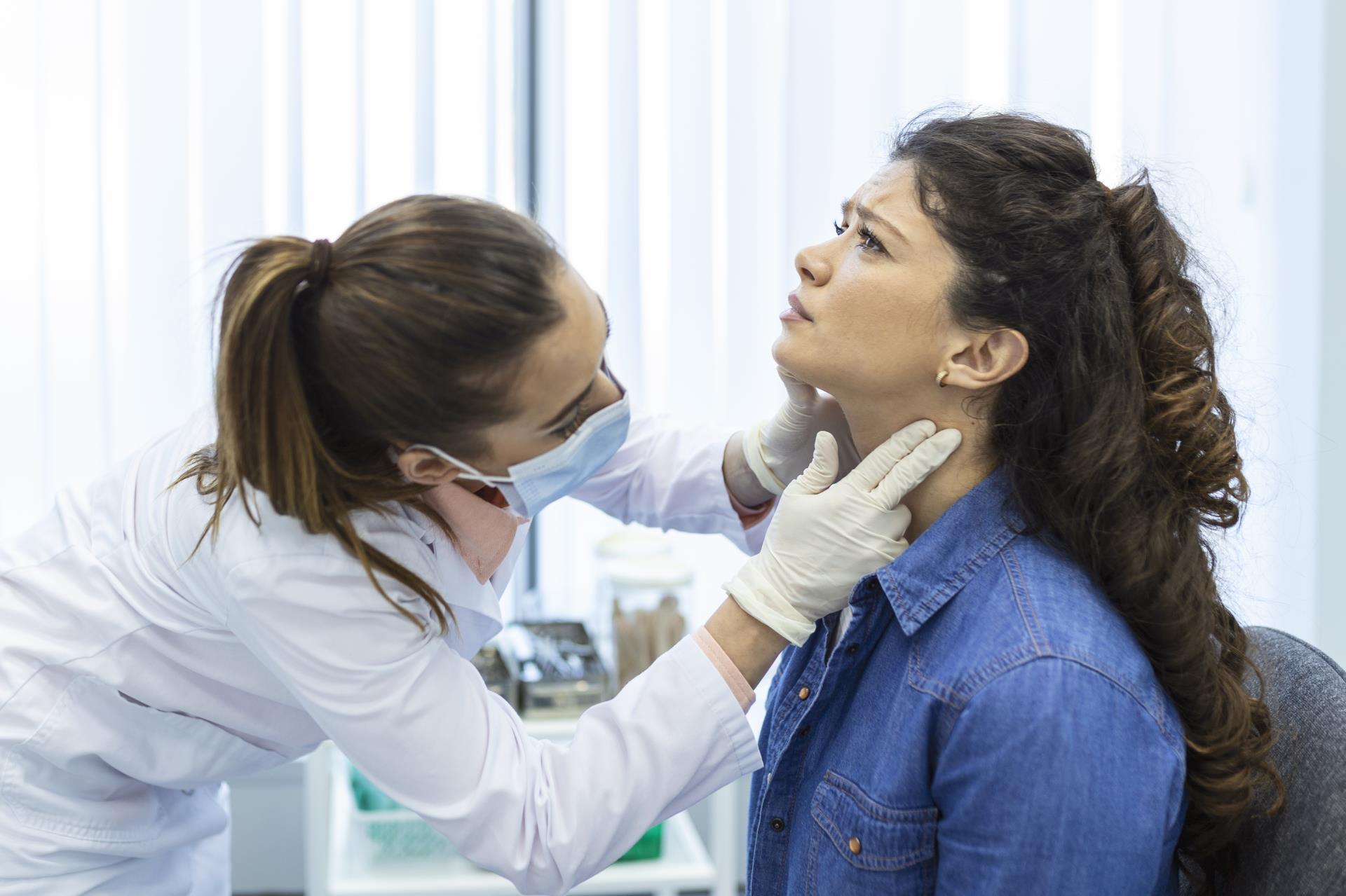 endocrinologist-examining-throat-young-woman-clinic-women-with-thyroid-gland-test-endocrinology-hormones-treatment-inflammation-sore-throat