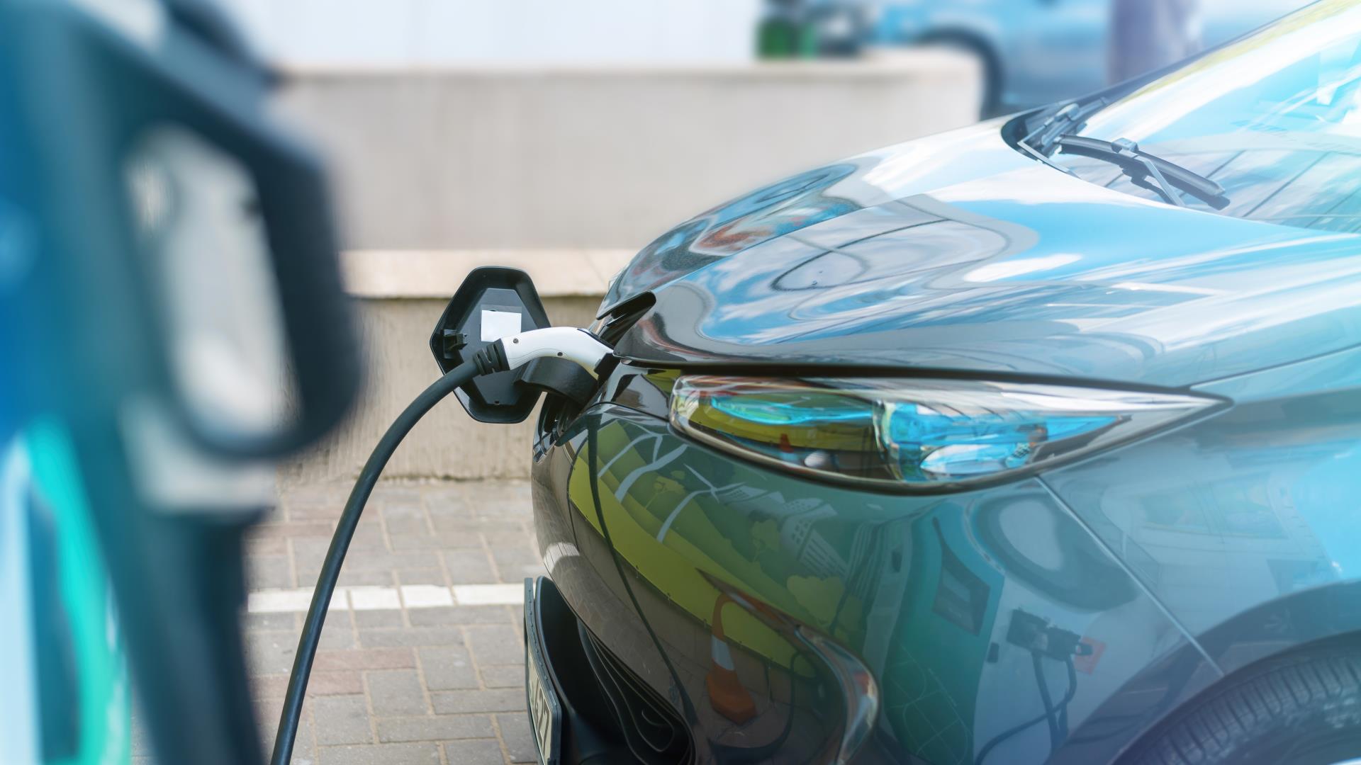 plugged-charger-into-electric-car-charge-station