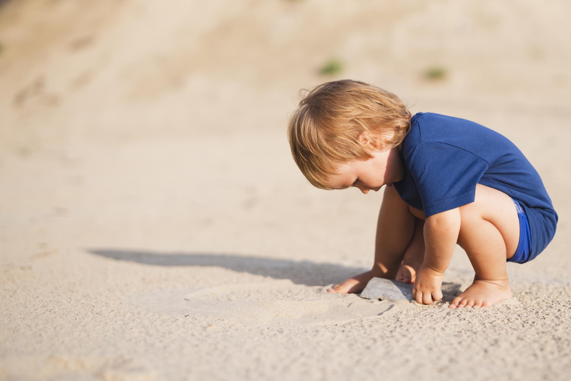 little-boy-beach-playing-with-sand