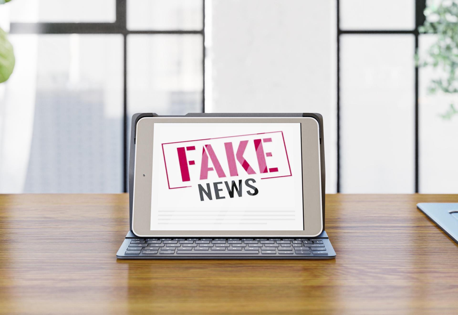 front-view-laptop-desk-with-fake-news