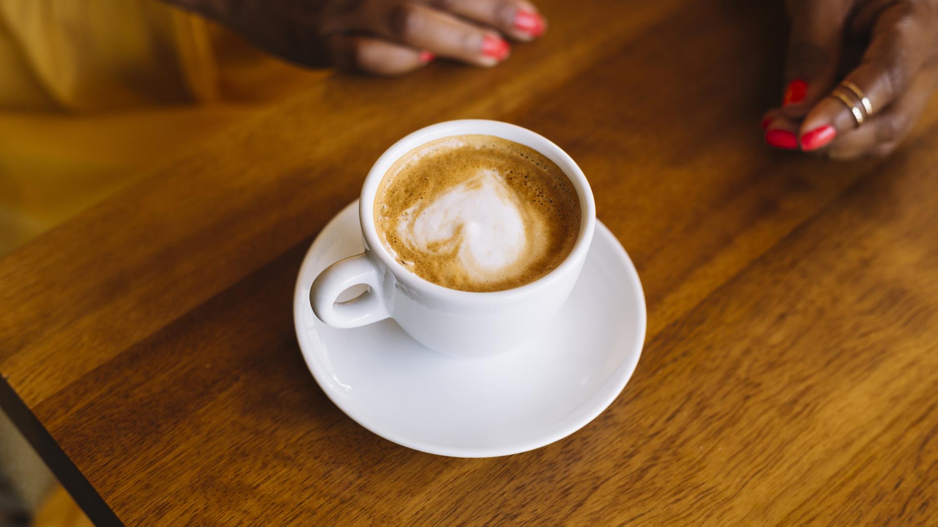 cup-cappuccino-coffee-with-heart-shape-latte-art-wood-surface