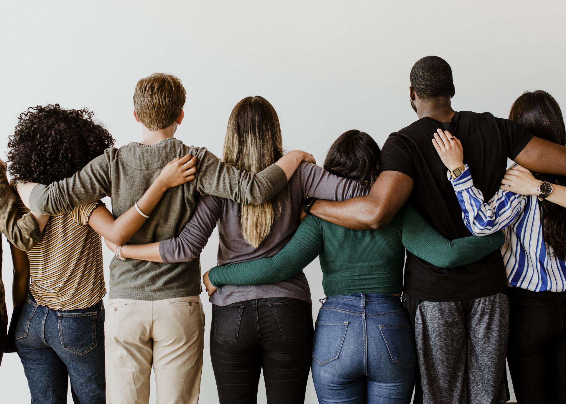 rearview-diverse-people-hugging-each-other