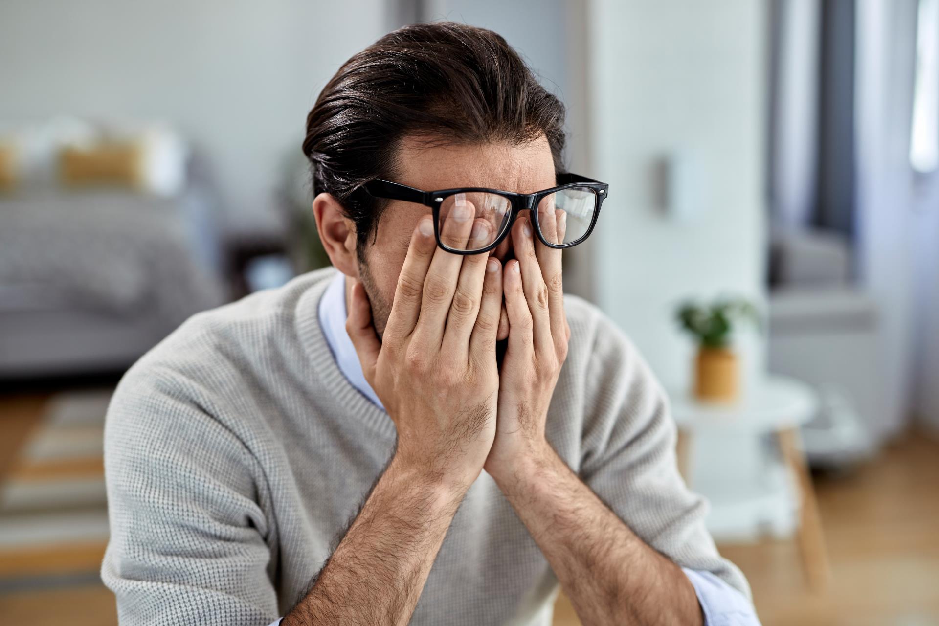 young-businessman-feeling-exhausted-while-working-home