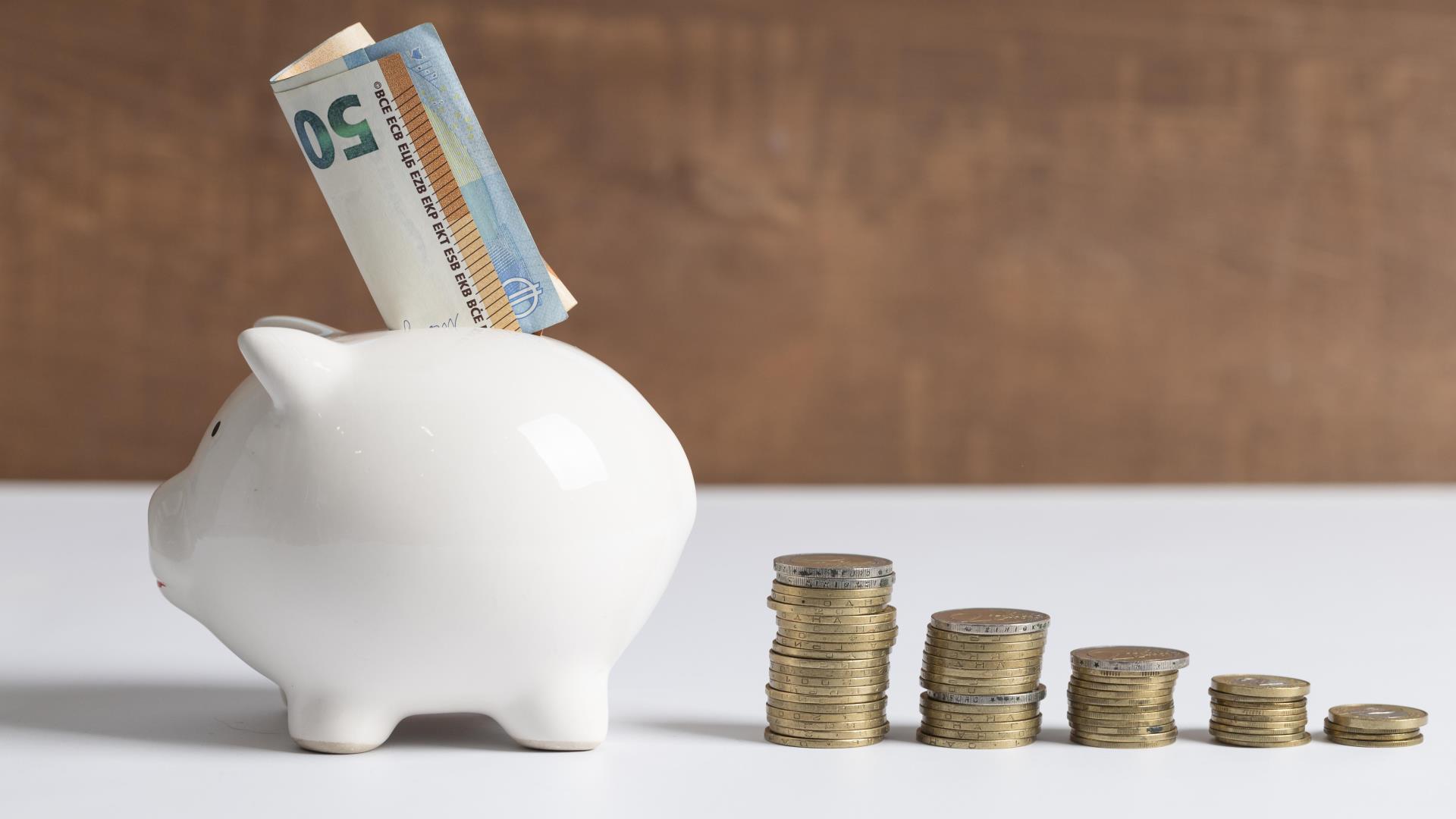 side-view-piggy-bank-with-coins-banknotes