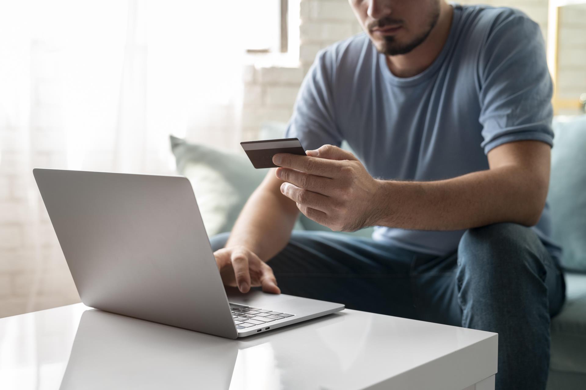 man-using-his-credit-card-play-online-order