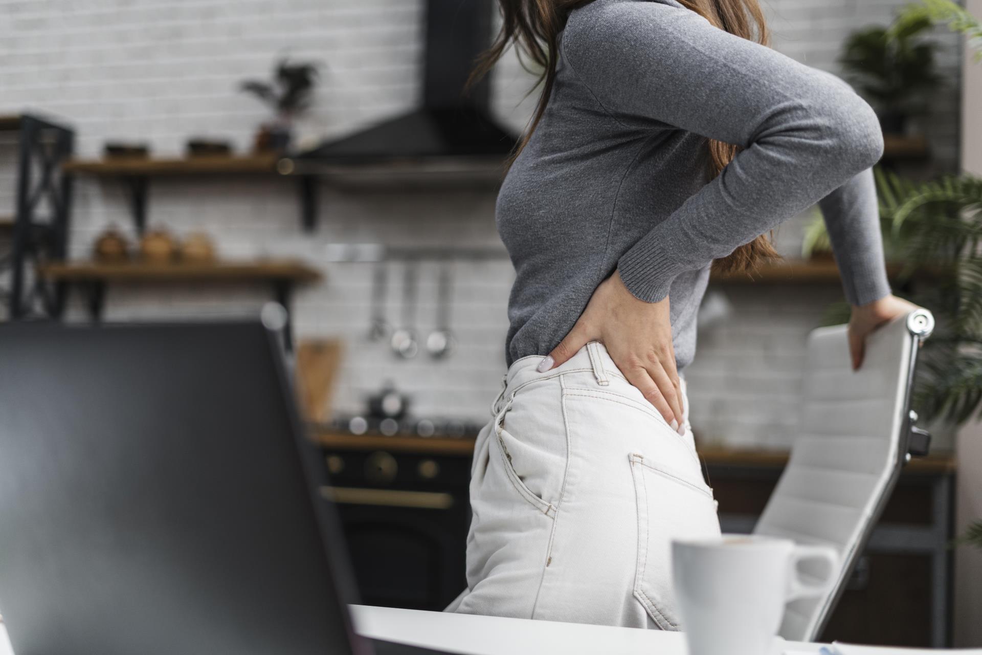 side-view-woman-having-backache-while-working-from-home