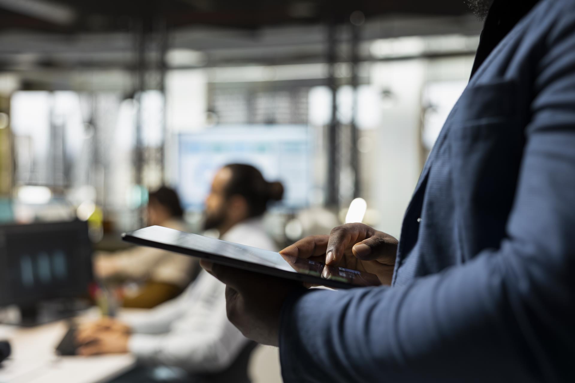 close-up-black-advisor-engaged-planning-with-analytics-tablet-creating-strategy-reports