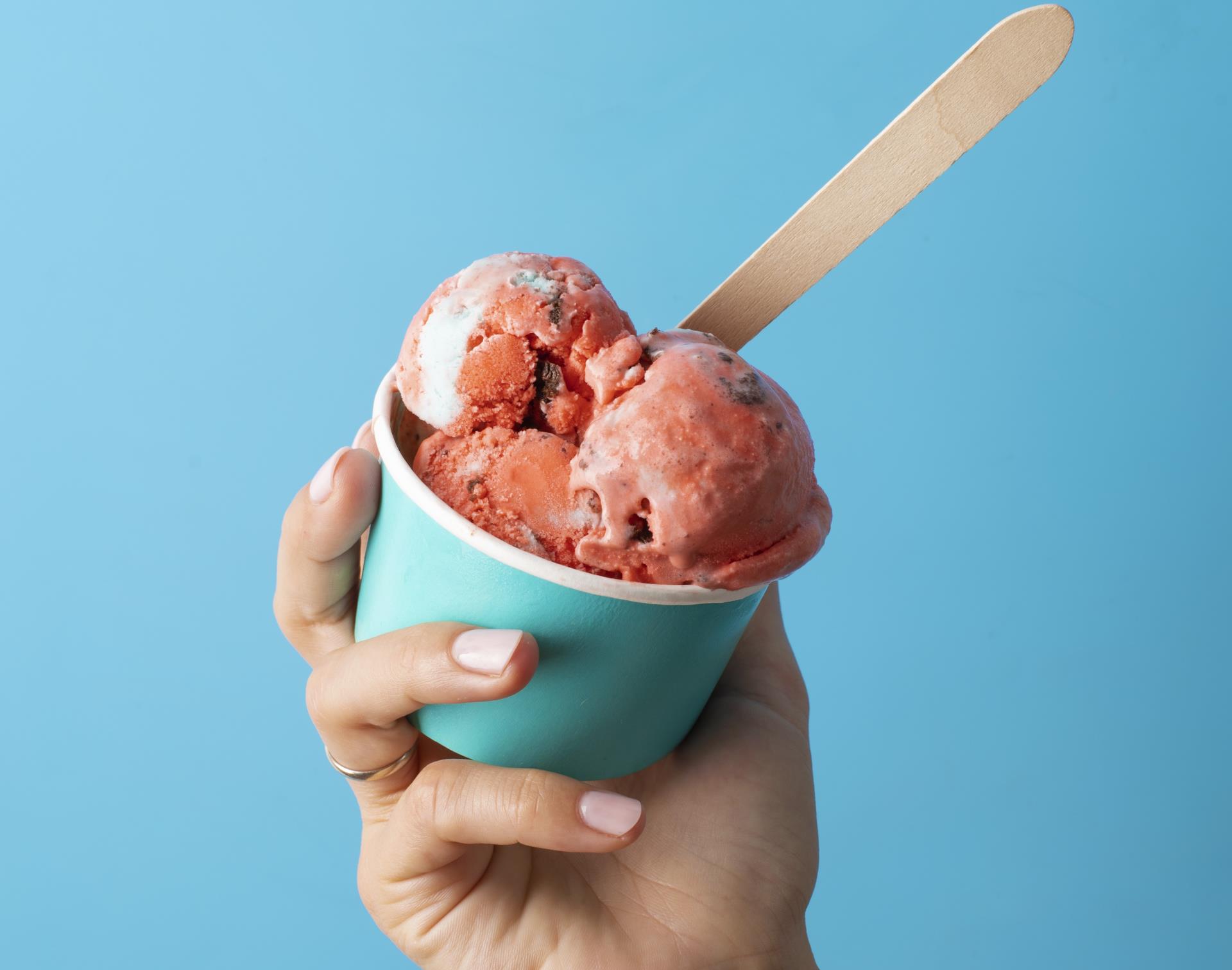 high-angle-hand-holding-ice-cream-cup