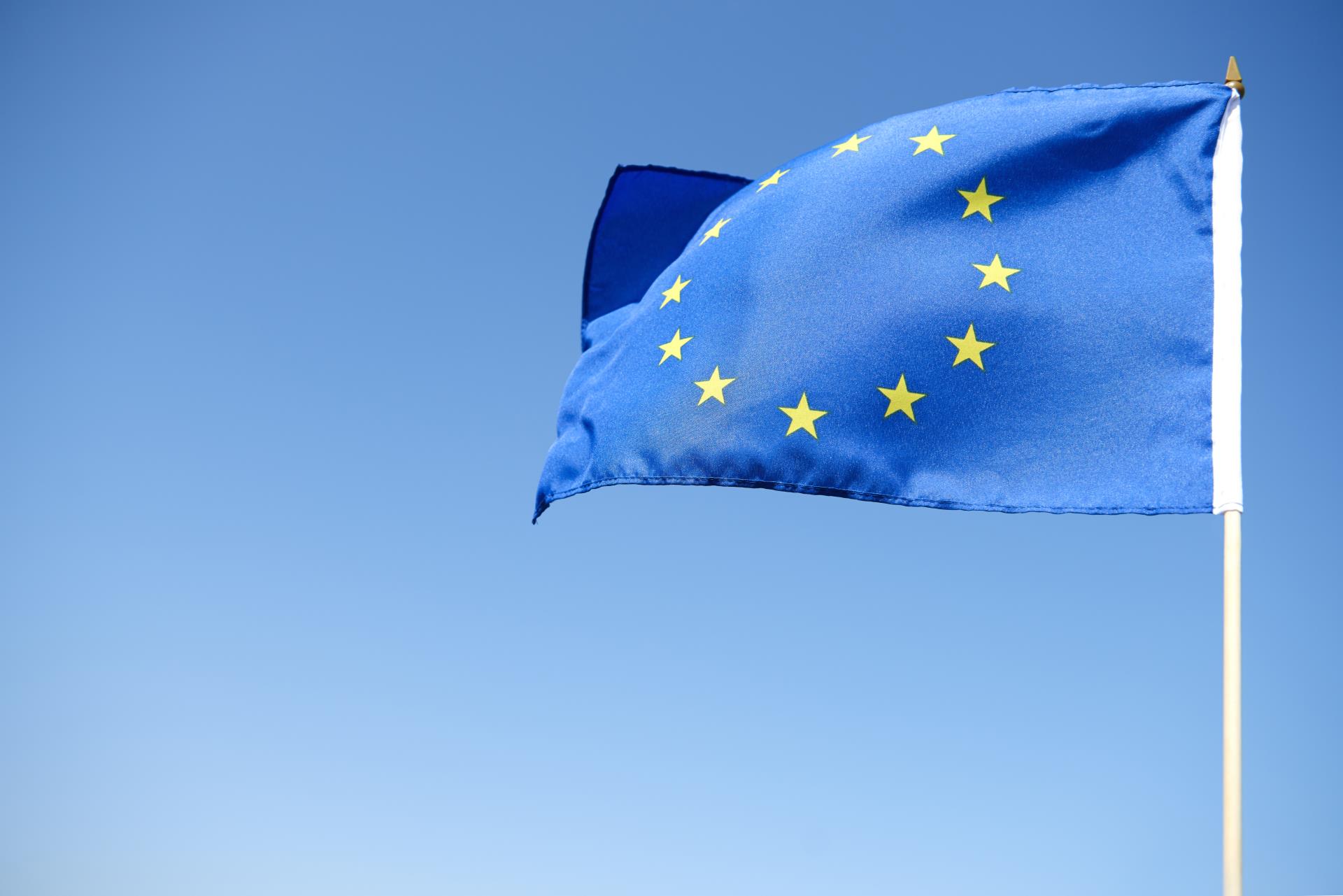 waving-european-union-flag-blue-background