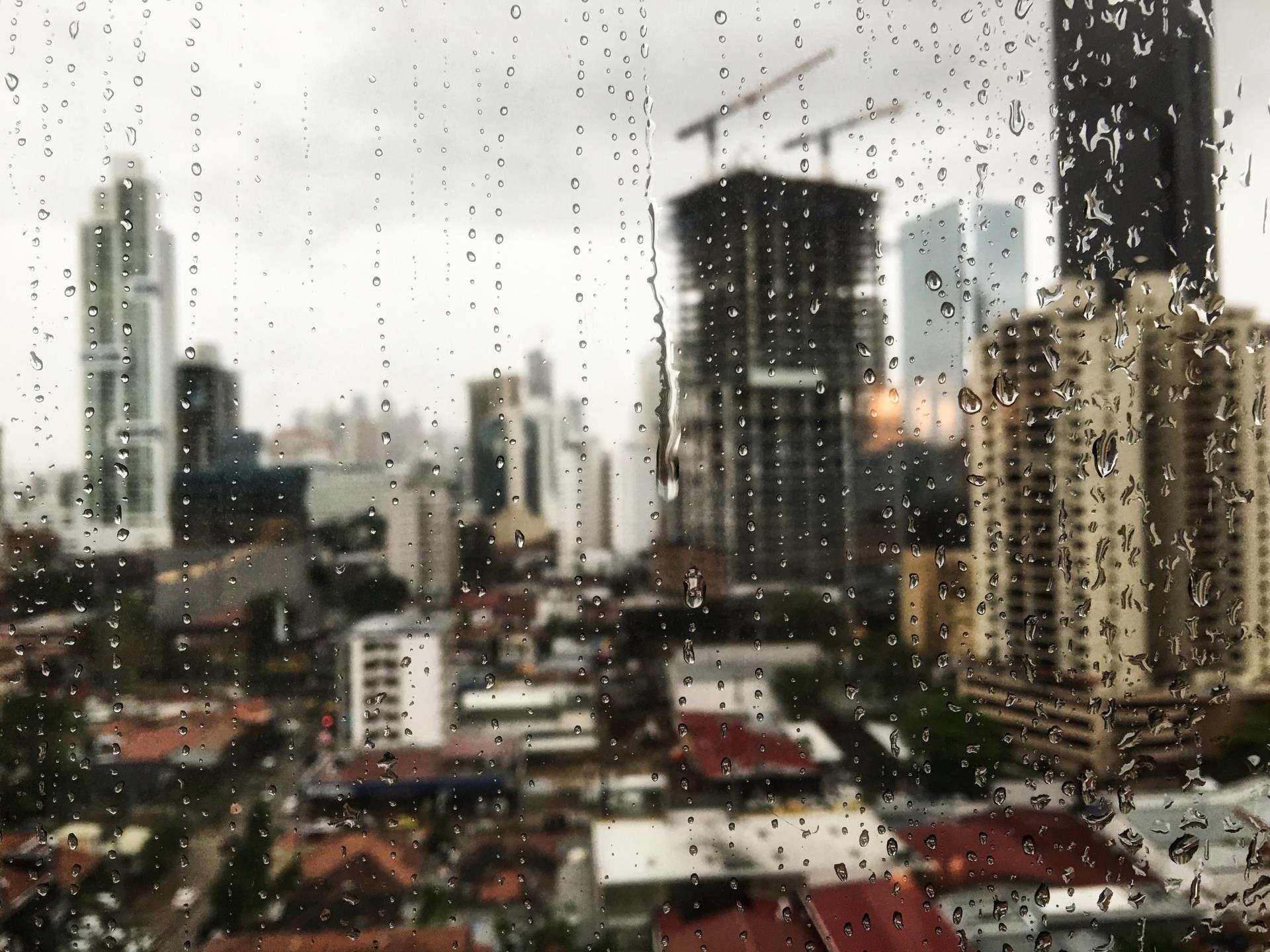 beautiful-view-raindrops-rolling-down-window-skyscrapers-surface