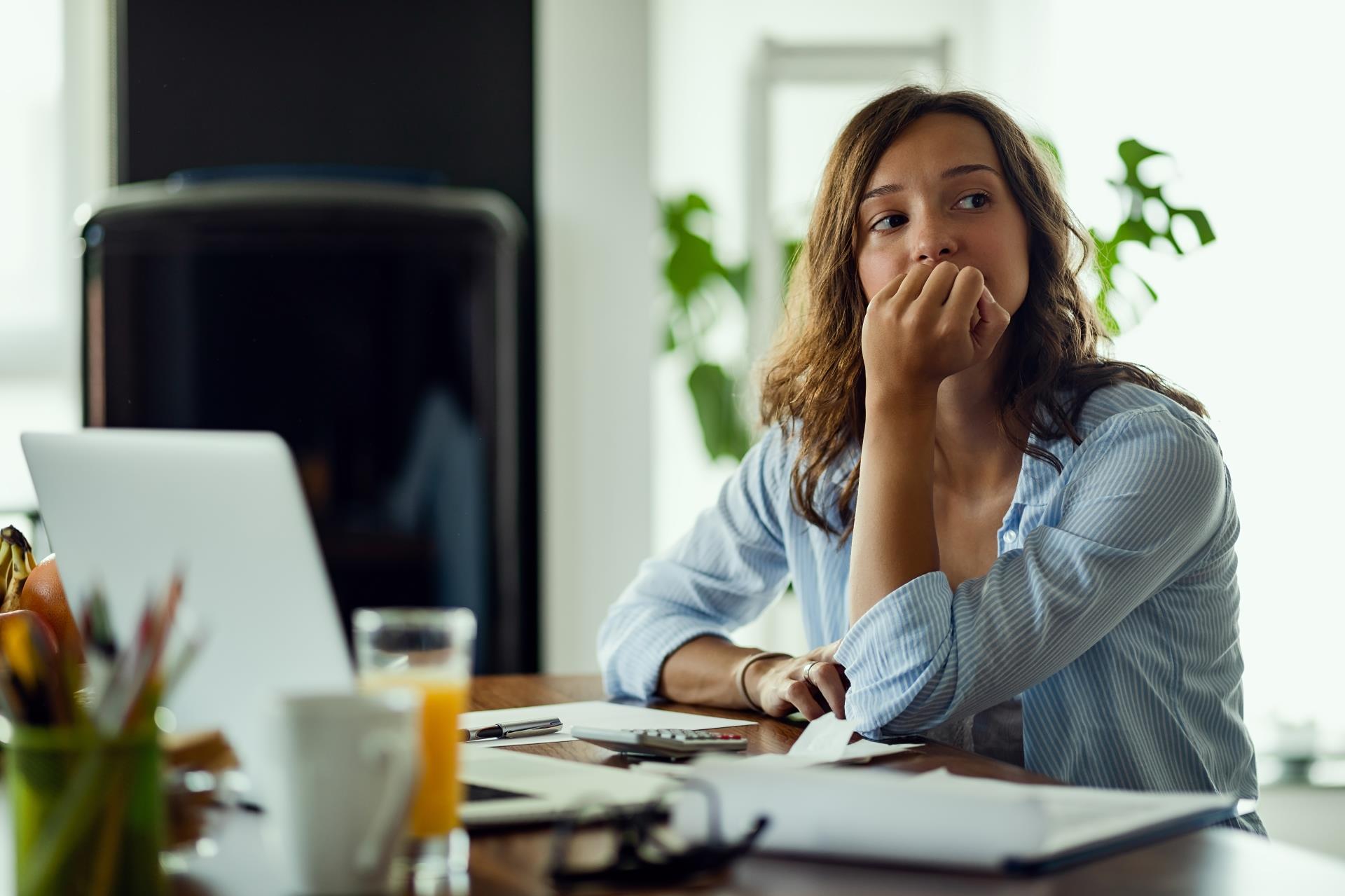 young-worried-woman-thinking-something-while-calculating-her-home-budget