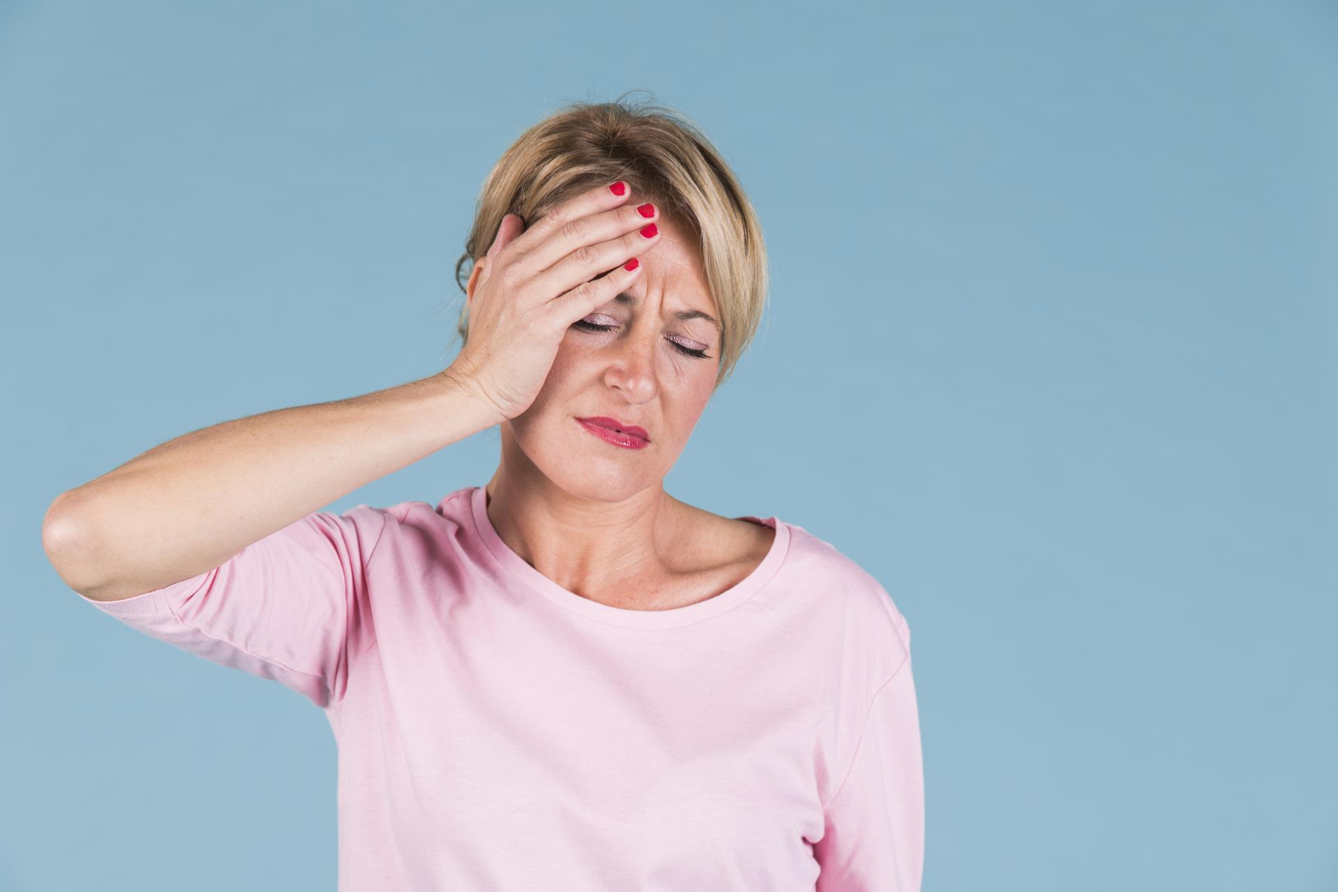 unhappy-woman-suffering-from-headache-against-colored-background