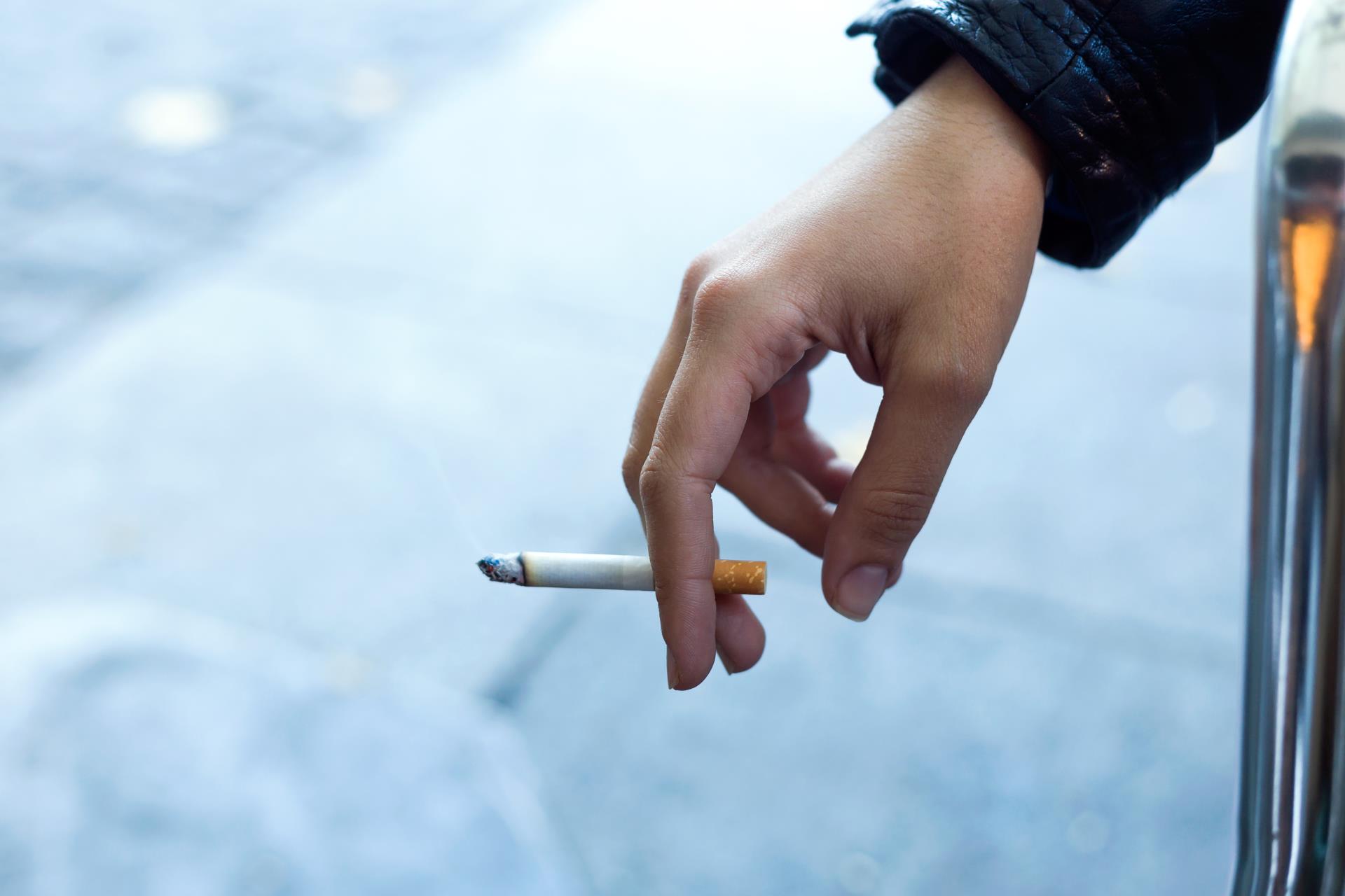 womans-hand-with-cigarette-street