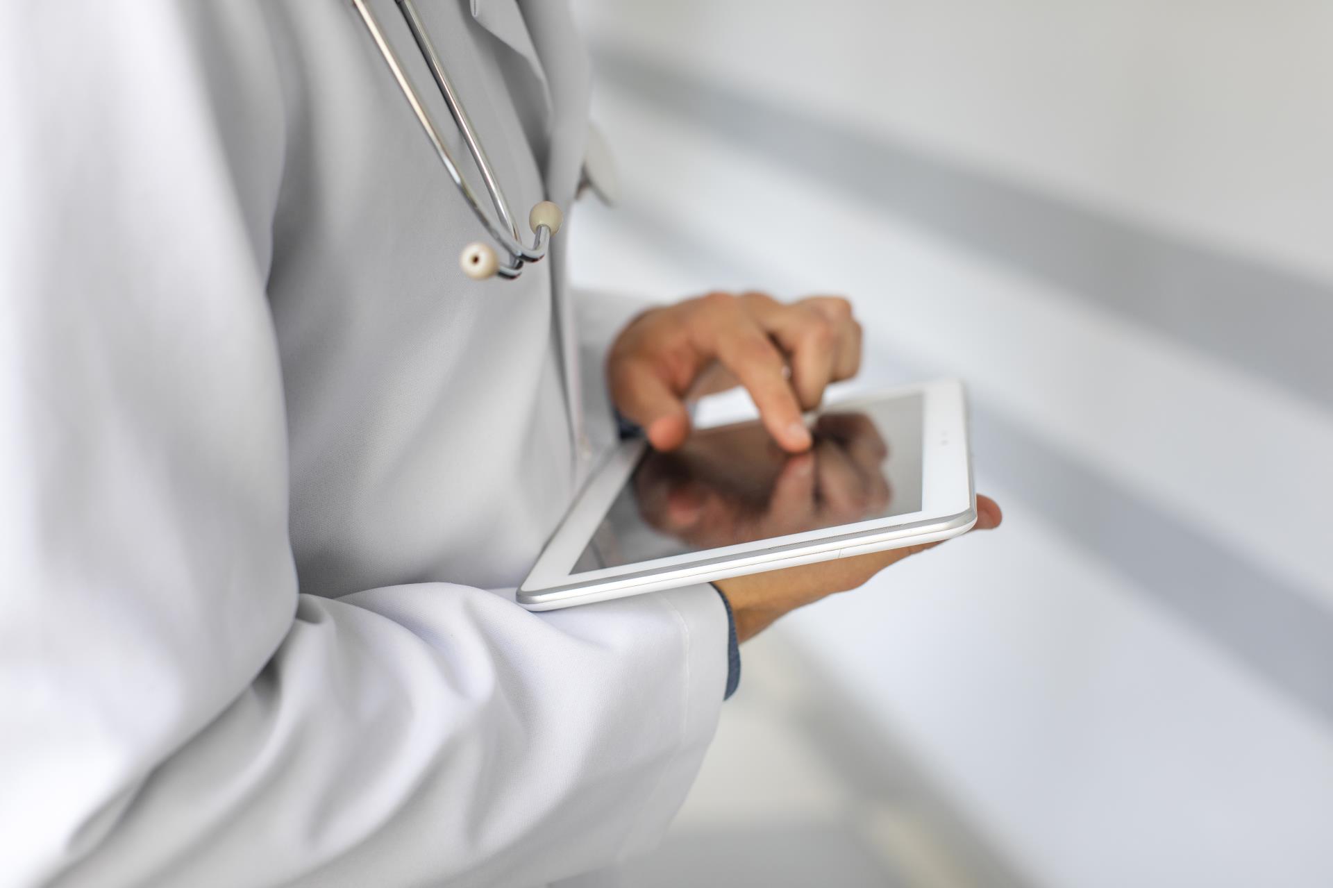 doctor-hands-using-modern-tablet