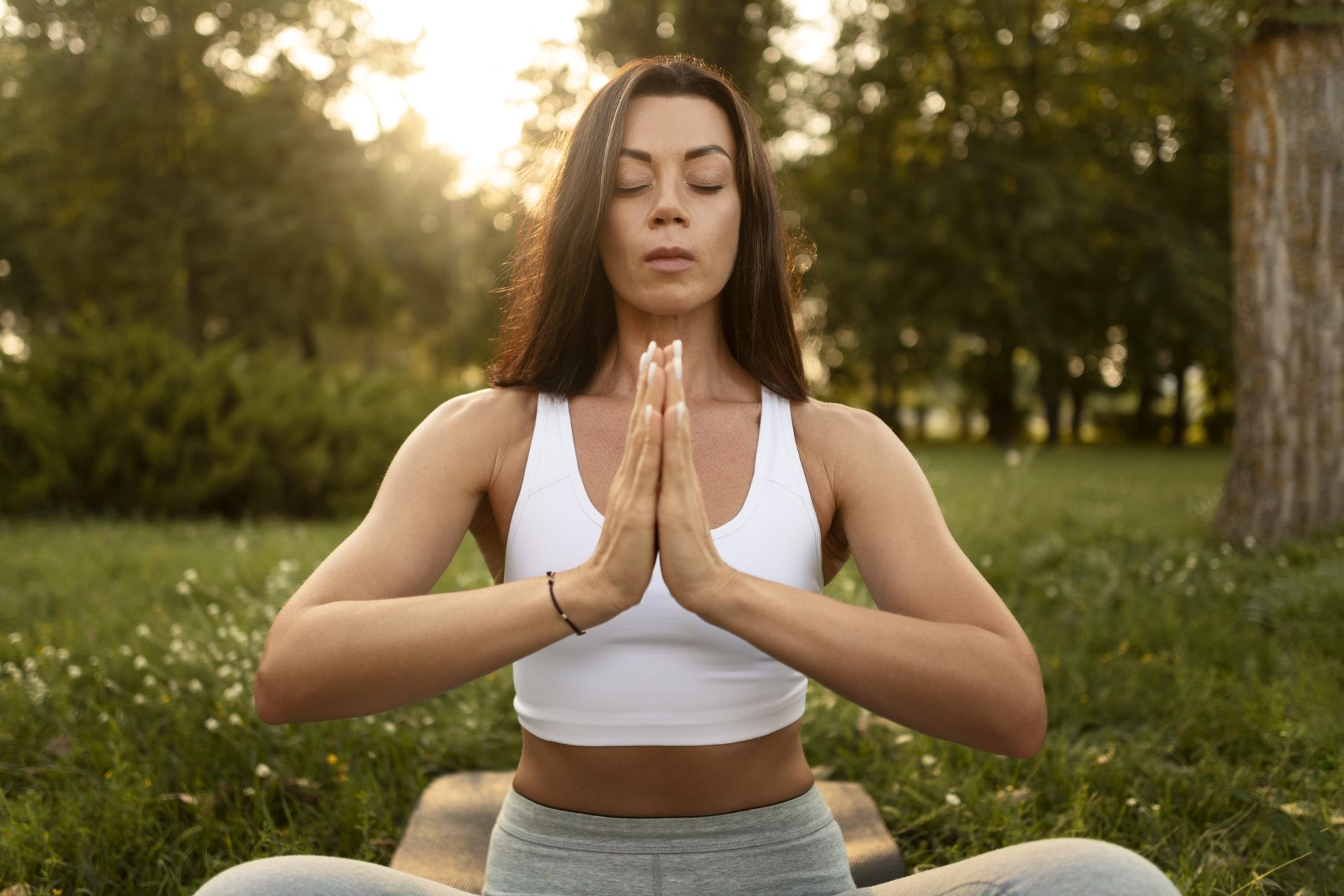 woman-meditating-outdoors-front-view