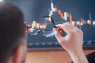 analyzing-data-close-up-young-businessman-who-holds-glasses-looks-gff-while-working-creative-office