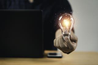 businessman-hand-holding-lightbulb-with-glowing-light-creative-smart-thinking-inspiration-innovation-with-network-concept