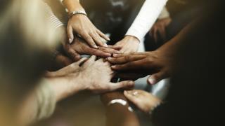 closeup-diverse-people-joining-their-hands