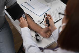high-angle-doctor-checking-patient