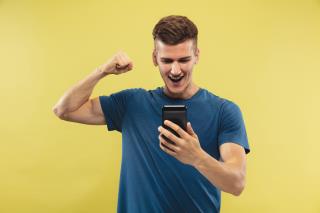 caucasian-young-man-s-half-length-portrait-yellow-studio-background-beautiful-male-model-blue-shirt-concept-human-emotions-facial-expression-sport-betting-online-purchases-sale