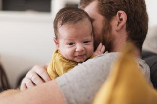 close-up-dad-sitting-couch-with-baby