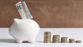 side-view-piggy-bank-with-coins-banknotes