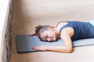 fitness-young-woman-lying-exercise-mat-wooden-background