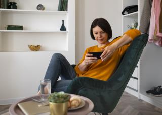 full-shot-woman-playing-with-her-phone