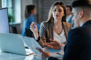 business-coworkers-cooperating-while-going-through-paperwork-analyzing-business-plans-work-focus-is-woman