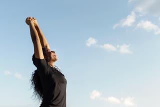 side-view-woman-stretching-with-copy-space-clear-sky