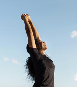 side-view-woman-stretching-with-copy-space-clear-sky