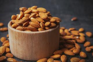 peeled-almonds-wooden-bowl-dark-table