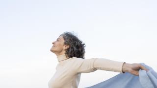 older-woman-enjoying-her-time-beach