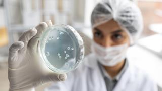 close-up-blurry-scientist-holding-petri-dish