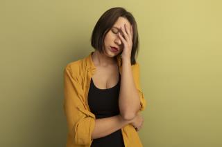 tired-pretty-woman-puts-hand-forehead-isolated-olive-green-wall