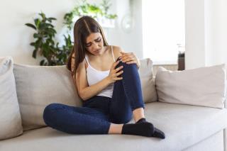 woman-holding-knee-with-pain-sofahealth-care-medical-concept