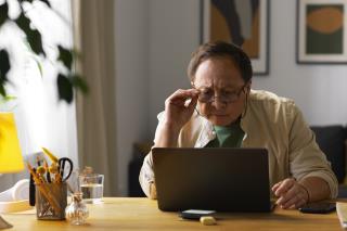 portrait-older-man-using-laptop-home