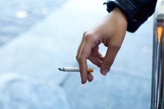 womans-hand-with-cigarette-street