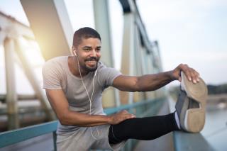 young-smiling-sportsman-preparing-running