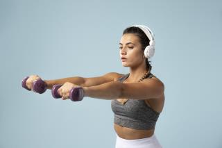 young-woman-doing-exercises-with-her-headphones